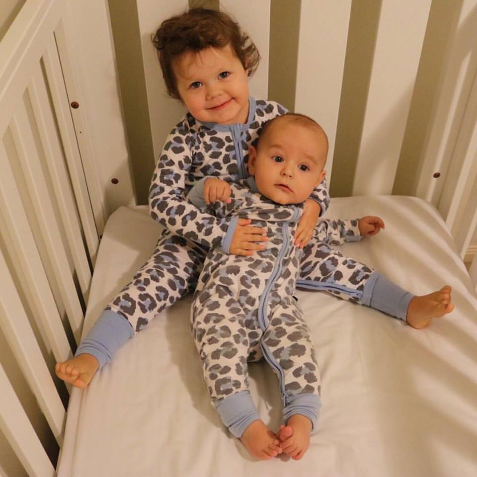 Melanie’s children the siblings are in the cot at bedtime in their togs